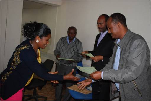 four people receiving certificates