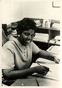 woman smiling at her desk