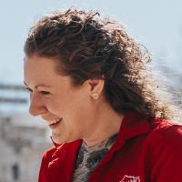 profile headshot of a smiling woman looking to the left with text