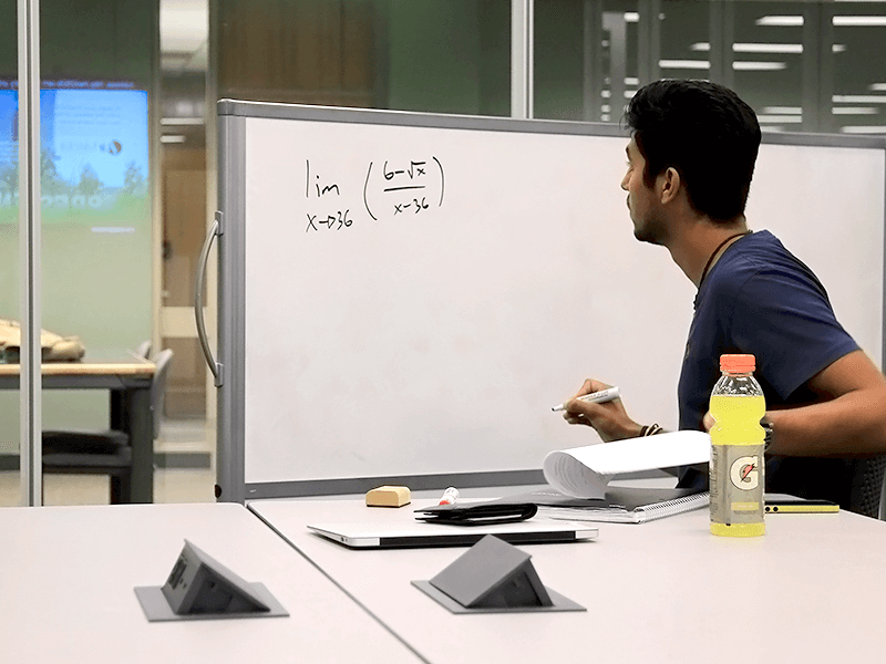 man writing on mobile whiteboard