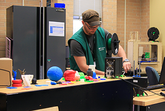 man creating an object with the 3D printer