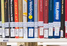 several colorful books on a shelf